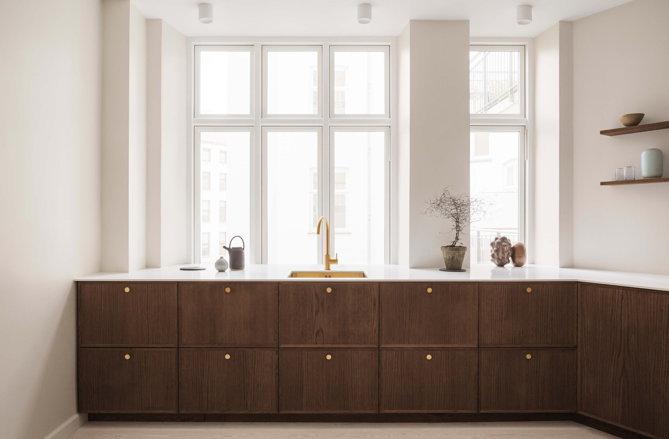 FRAME Dark Oak kitchen cabinets with brass knobs